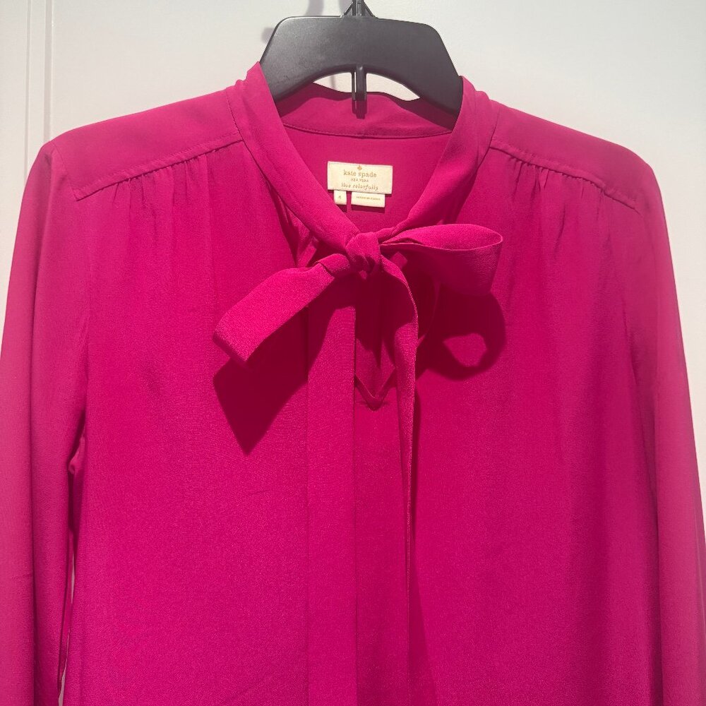 Kate Spade  tie-neck blouse in hot pink. Long sleeves, button cuffs, great con